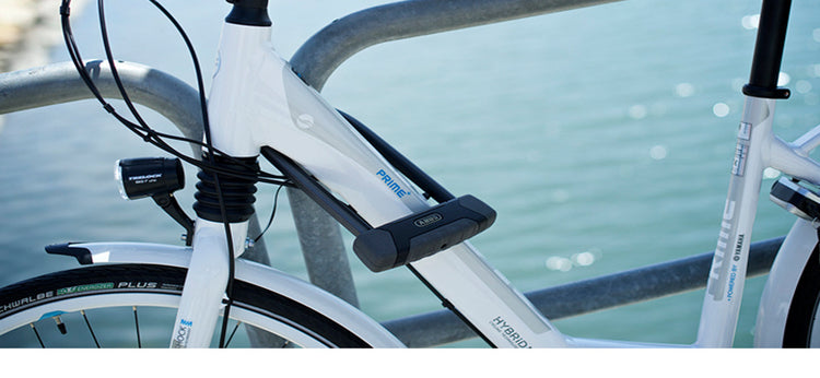white bike locked with u-lock