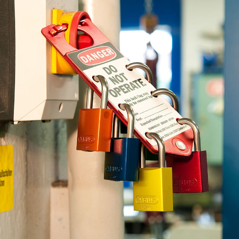 Load image into Gallery viewer, Colorful ABUS 72 series padlocks with a lockout tagout label attached to a metal surface.