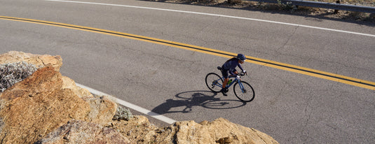 road cyclist riding up mountain road