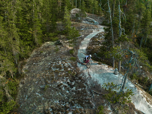 mountain biker riding a rocky trail in the mountains