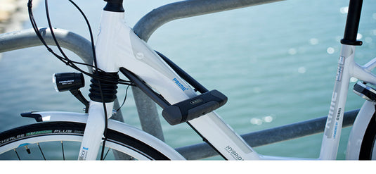 white bike locked with u-lock