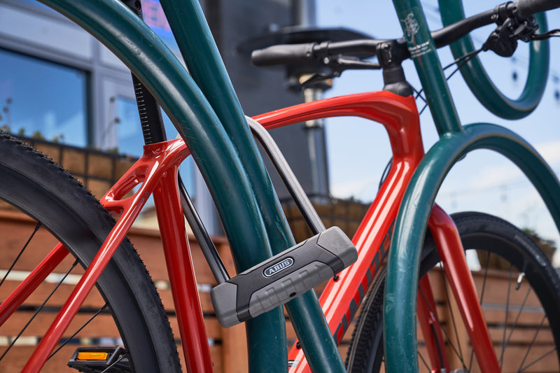 Load image into Gallery viewer, 540 u-lock securing red bike to bike rack
