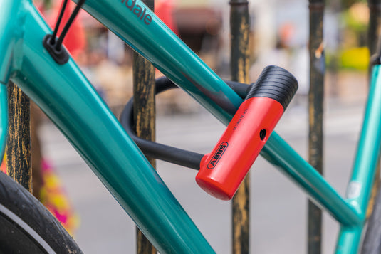 Turquoise bike secured to fence with Ultimate 420K mini