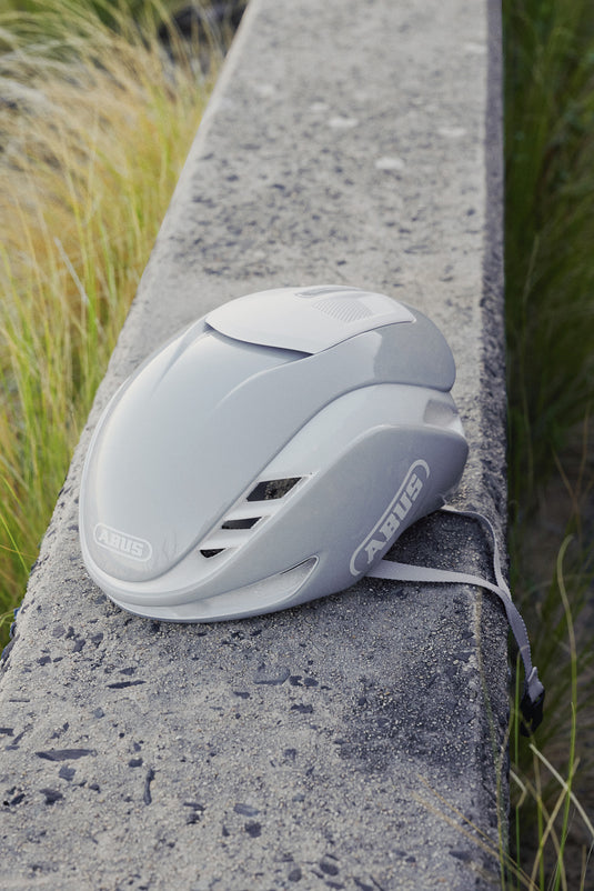 grey ABUS GameChanger 2.O Pure helmet sitting on concrete wall