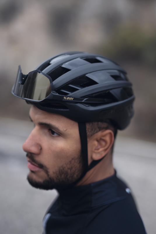 Man wearing a black helmet with a blurred background