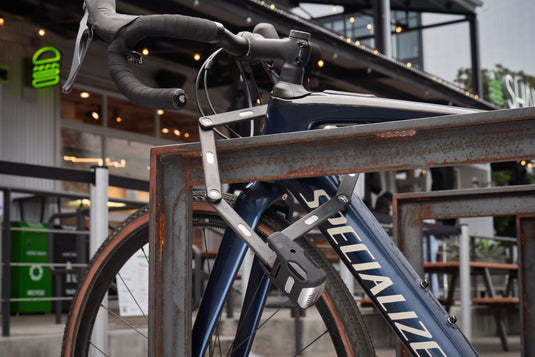 Close-up of a blue Specialized bicycle with a blurred indoor background locked with Bordo 6000KA