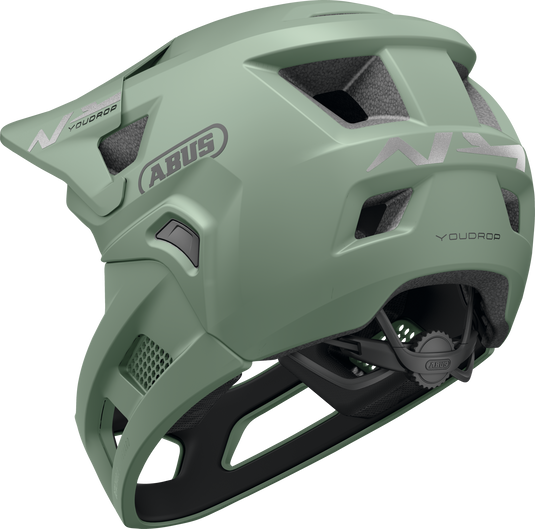 Green helmet with ABUS branding on a white background