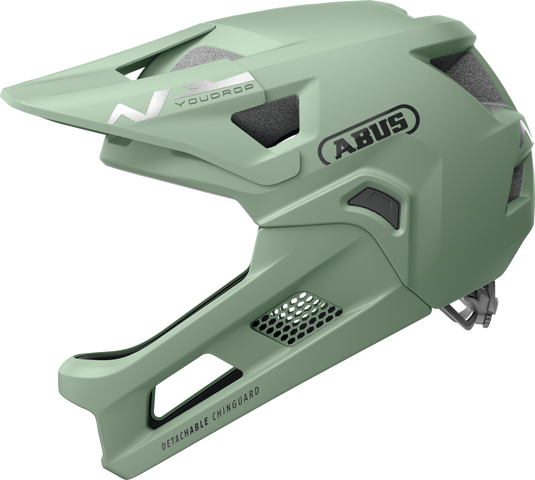 Green bicycle helmet with ABUS branding on a white background