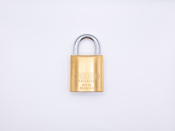 Gold 83-Series padlock on a white background