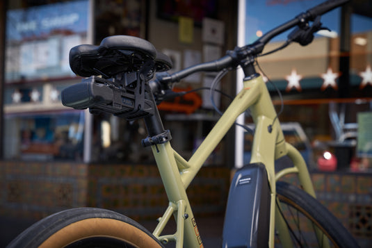 Light green electric bike with a blurred store interior background