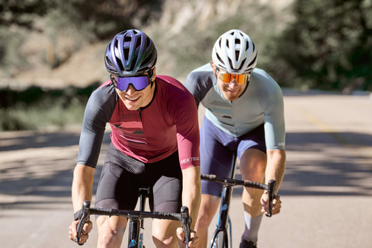 Two cyclists riding sngle file wearing ABUS StormChaser helmets