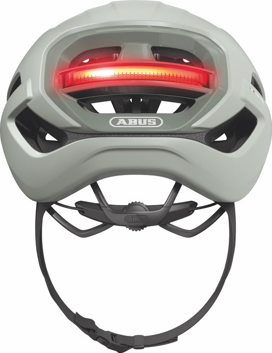 Green helmet with a red light on a white background