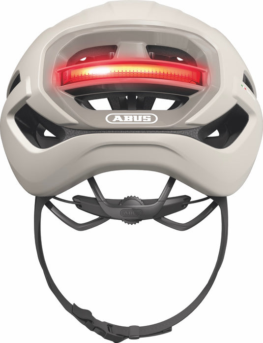 sand beige bicycle helmet with red light and ABUS logo on a white background