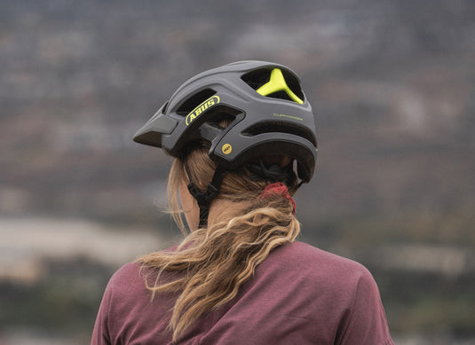 cyclist head from behind wearing grey ABUS CiliffHanger MIPS helmet