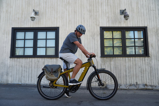 rider sitting on yellow e-bike wearing ABUS Pedelec 2.0 MIPS helmet