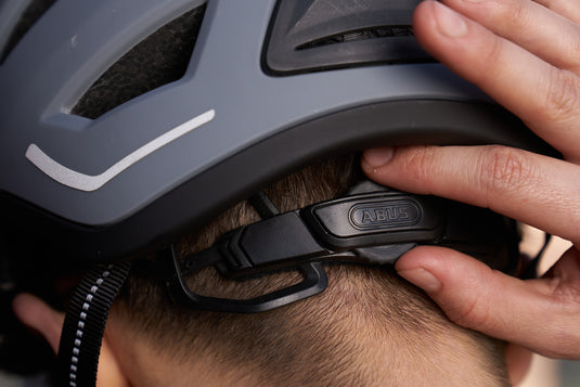 close-up shot of rider adjusting fit with ABUS zoom ace retention system