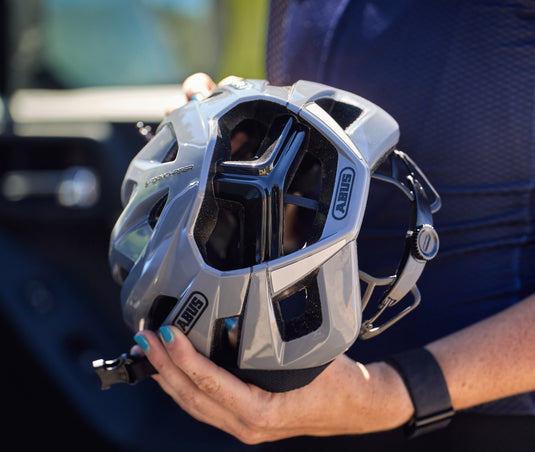 cyclist holding race grey ABUS StormChaser helmet