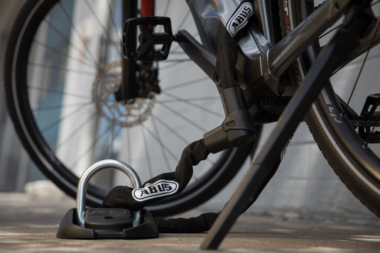 bike locked outside with floor anchor and chain